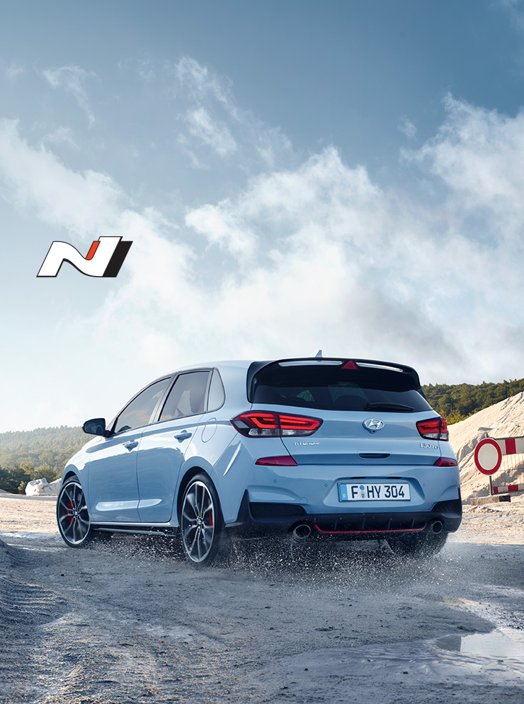 Left side rear view of blue i30 n driving on the off road